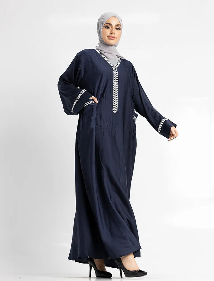 Navy blue dress with white embroidery on a white background