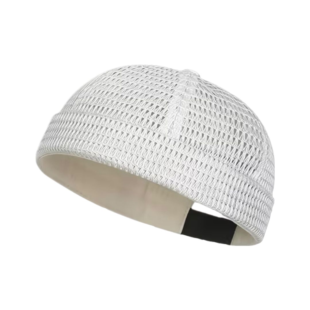 A white open-knit skullcap with a beige inner lining and a black adjustable hook-and-loop strap, shown on a plain white background.