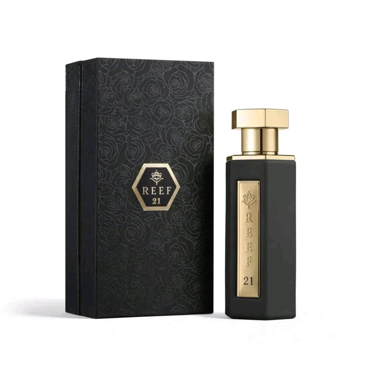 Black and gold perfume bottle with packaging featuring 'REEF 21' branding on a white background.