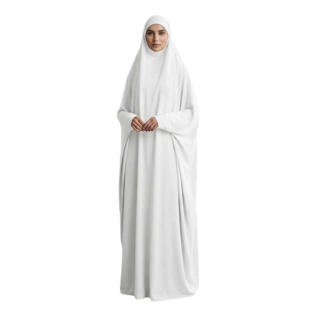 A woman wearing a full-length white modest garment with a matching head covering, shown against a plain white background.