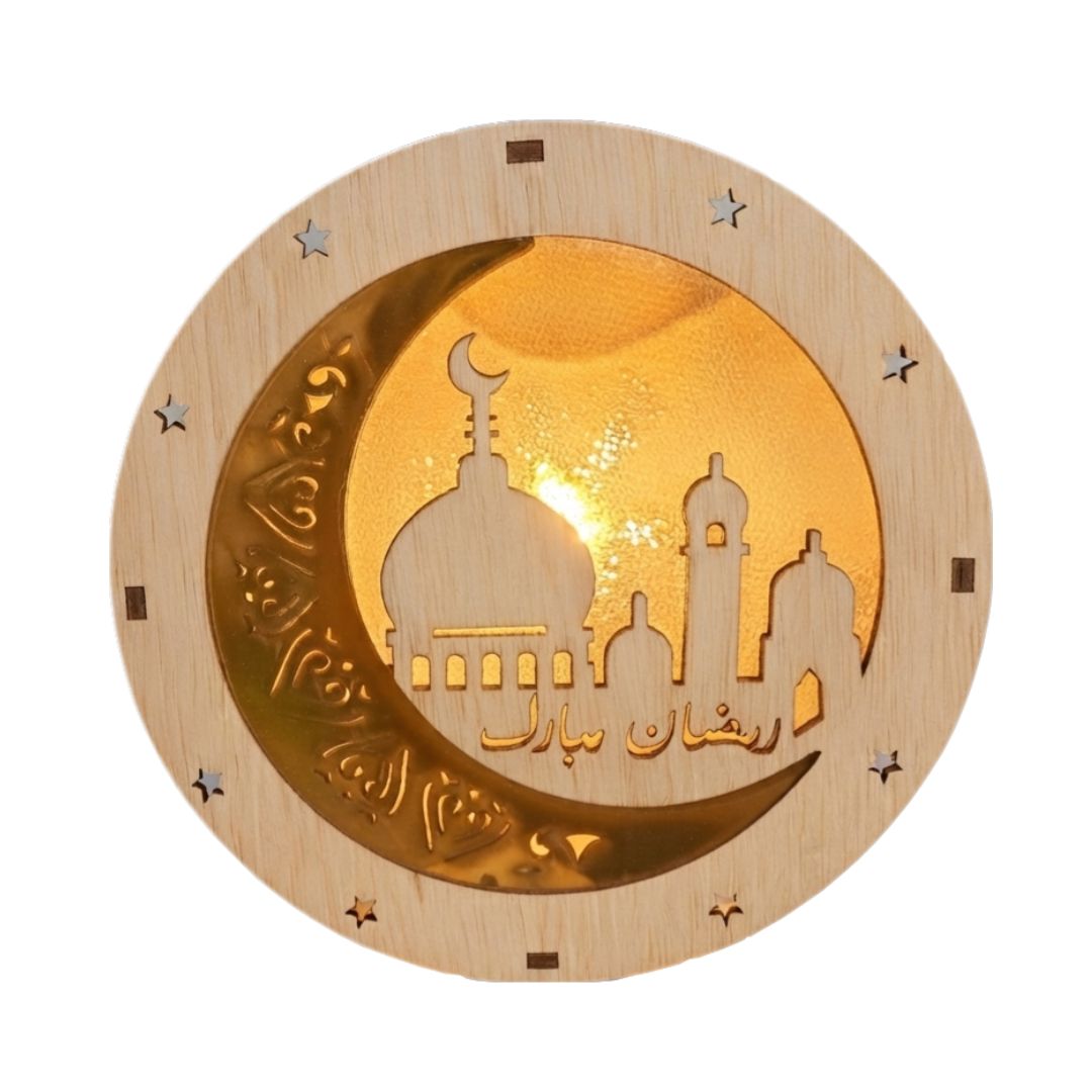 A round wooden Islamic wall plaque featuring a glowing gold crescent moon and mosque silhouette with Arabic calligraphy, set against a plain white background.